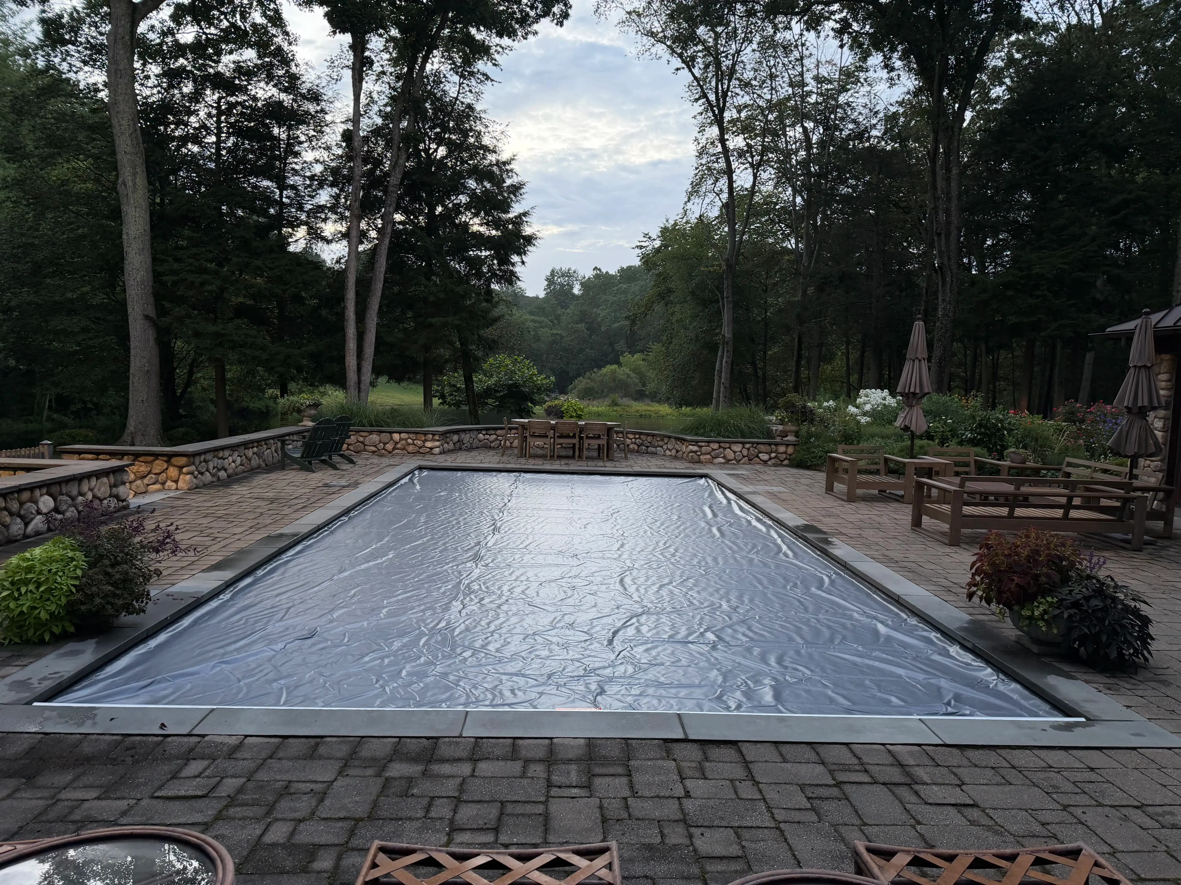 Automatic pool cover closed over a residential in-ground swimming pool