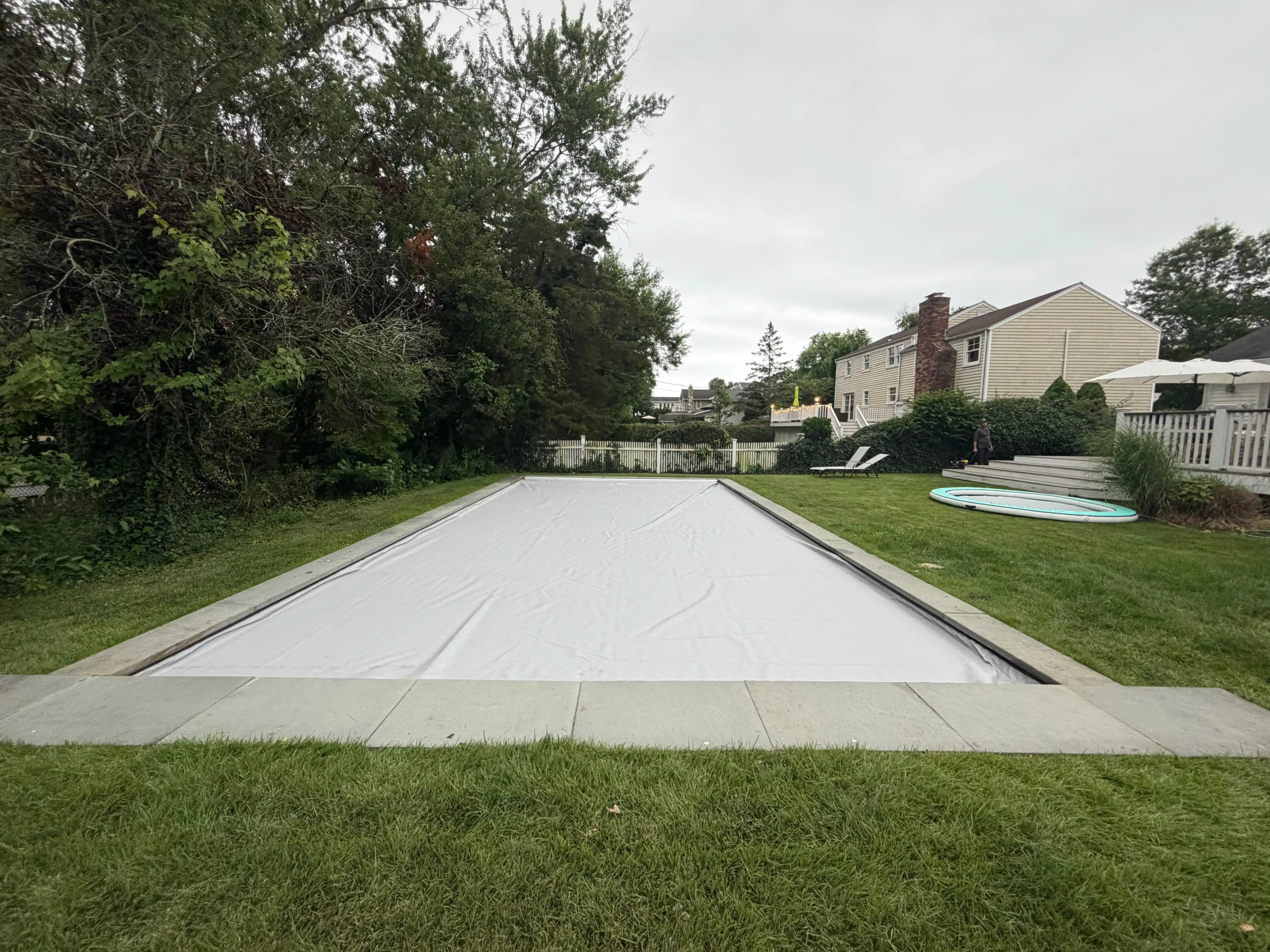 Automatic pool cover system installed on a large outdoor pool