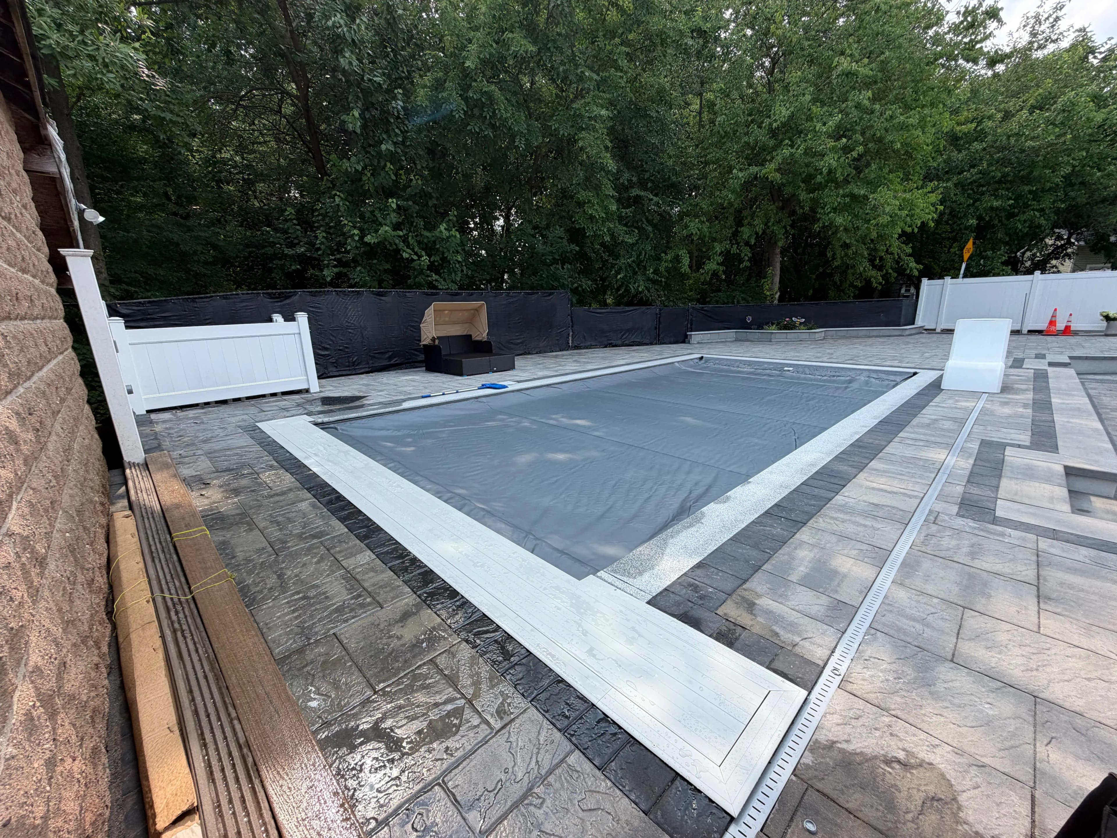 Automatic pool cover fully closed across a residential in-ground pool