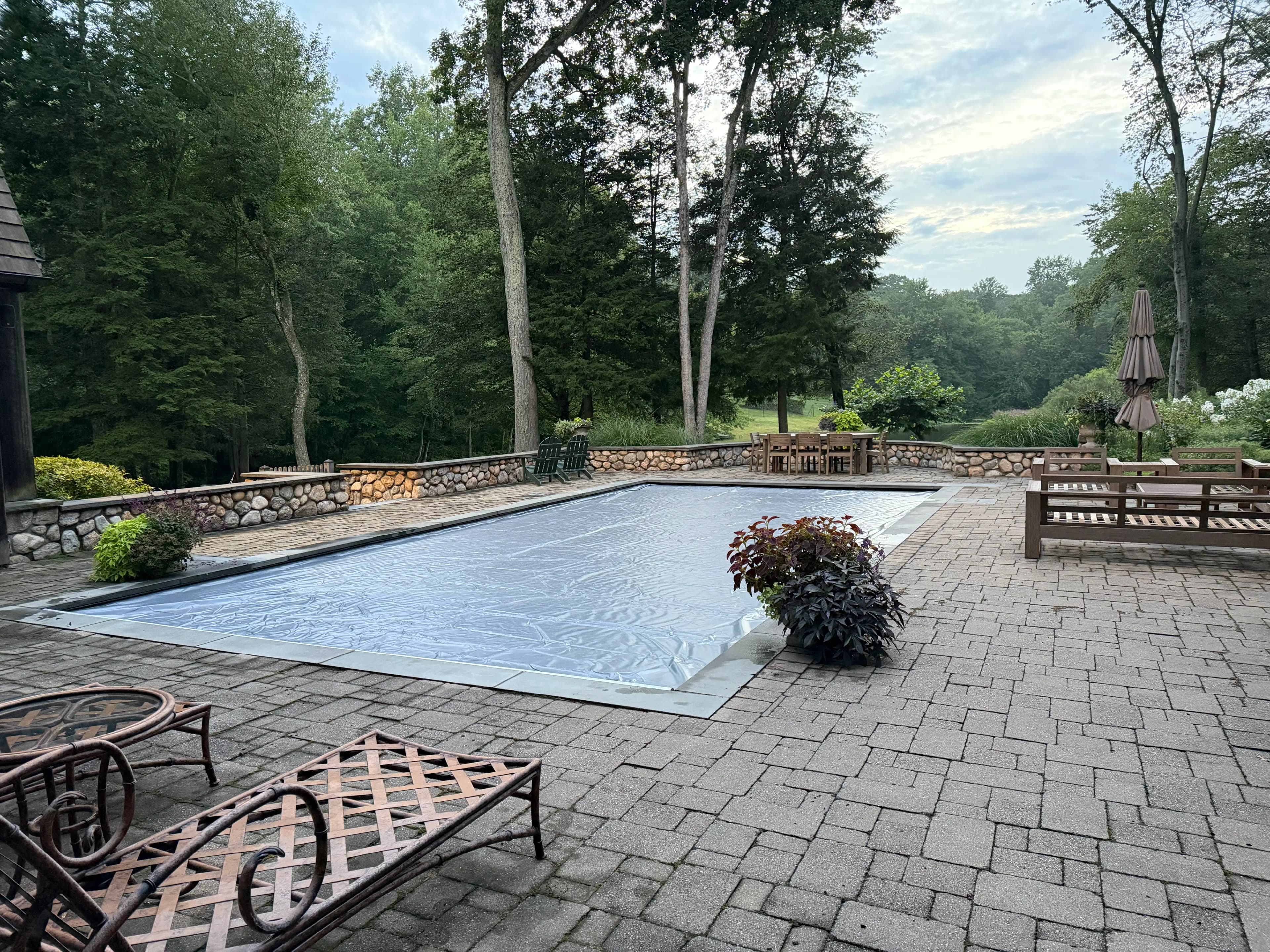 Safety pool cover fully extended over a residential swimming pool